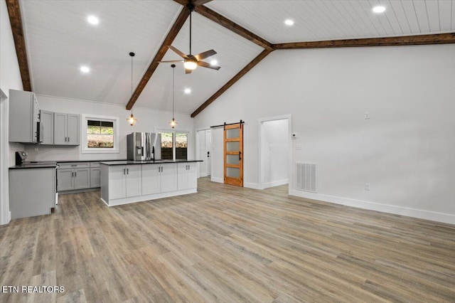 520 Ridge Rd, Caryville, TN 37714 - kitchen featuring stainless steel fridge, dark countertops, a barn door, beamed ceiling, and ceiling fan