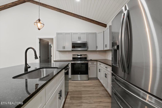 520 Ridge Rd, Caryville, TN 37714 - kitchen featuring stainless steel appliances, a sink, light wood-style flooring, pendant lighting, and dark stone countertops