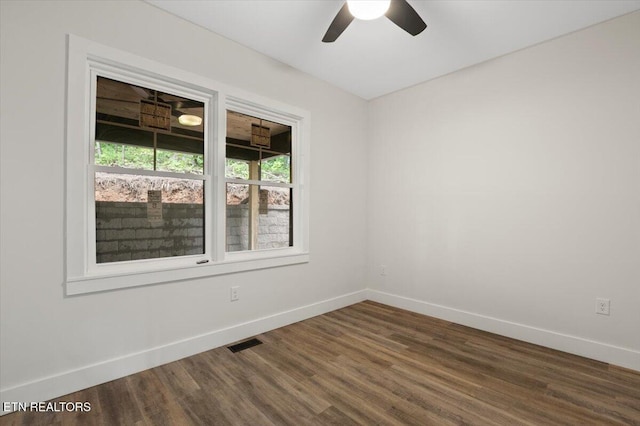 520 Ridge Rd, Caryville, TN 37714 - unfurnished room featuring baseboards, dark wood-style flooring, and a ceiling fan