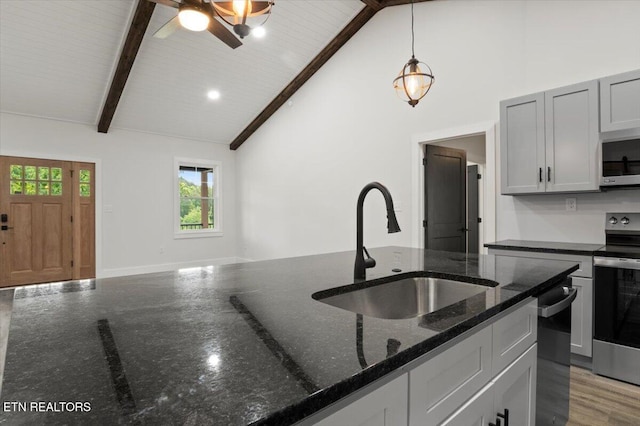 520 Ridge Rd, Caryville, TN 37714 - kitchen featuring stainless steel appliances, a sink, beamed ceiling, dark stone countertops, and ceiling fan