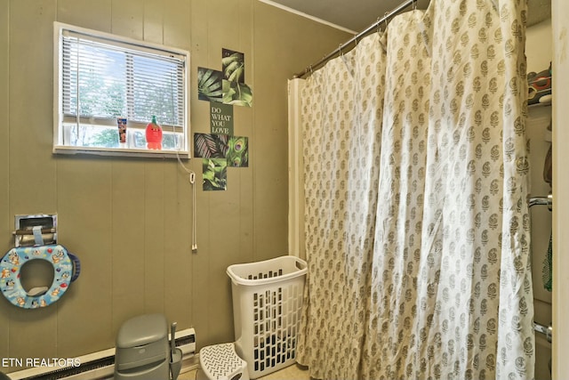 bathroom featuring curtained shower and a decorative wall