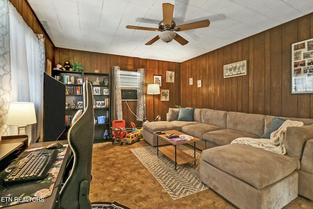 living room featuring wooden walls and ceiling fan