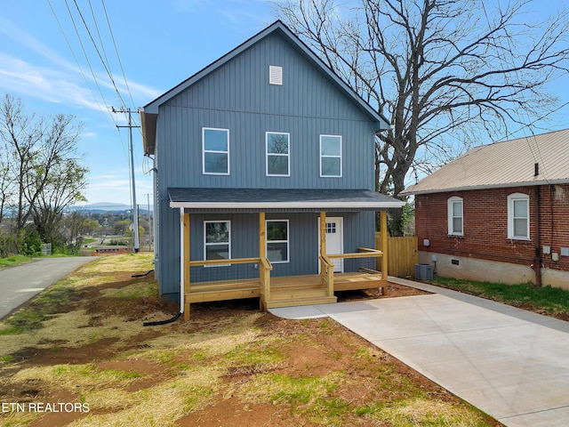 view of front of property featuring a shingled roof, cooling unit, a porch, and board and batten siding