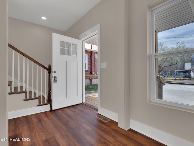 entrance foyer featuring stairs, dark wood-style floors, baseboards, visible vents, and recessed lighting