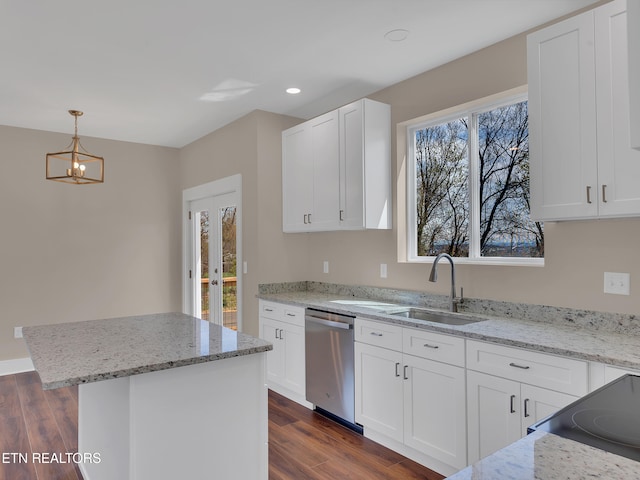 kitchen with dark wood-style flooring, dishwasher, white cabinetry, a sink, and decorative light fixtures
