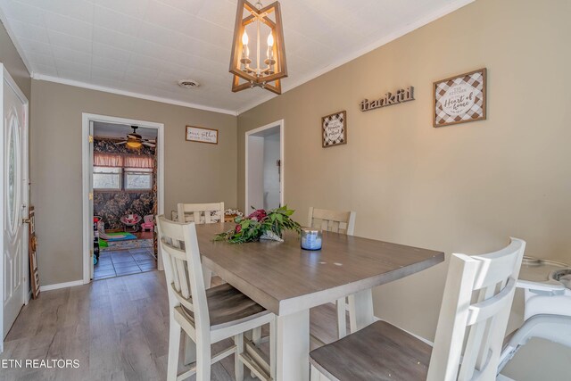 275 White Oak Rd, Oakdale, TN 37829 - dining room featuring crown molding, a chandelier, wood finished floors, baseboards, and visible vents