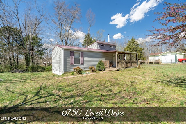 view of front of home featuring a front lawn and a deck