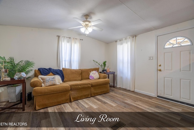 living room with lofted ceiling, ceiling fan, wood finished floors, and plenty of natural light