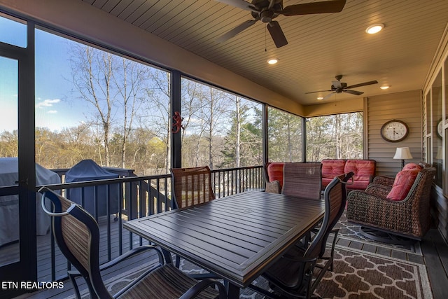 sunroom featuring ceiling fan and outdoor dining area