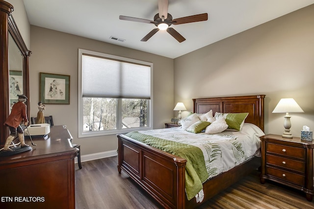 bedroom with dark wood-style floors, visible vents, baseboards, and a ceiling fan