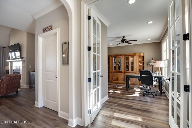 home office with french doors, a ceiling fan, crown molding, and wood finished floors