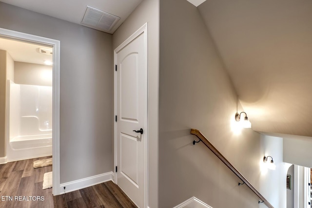 interior space with dark wood finished floors, baseboards, and visible vents