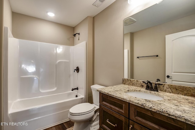 full bath with visible vents, toilet, wood finished floors, vanity, and shower / bath combination
