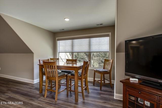 dining area featuring dark wood-style flooring, baseboards, and visible vents