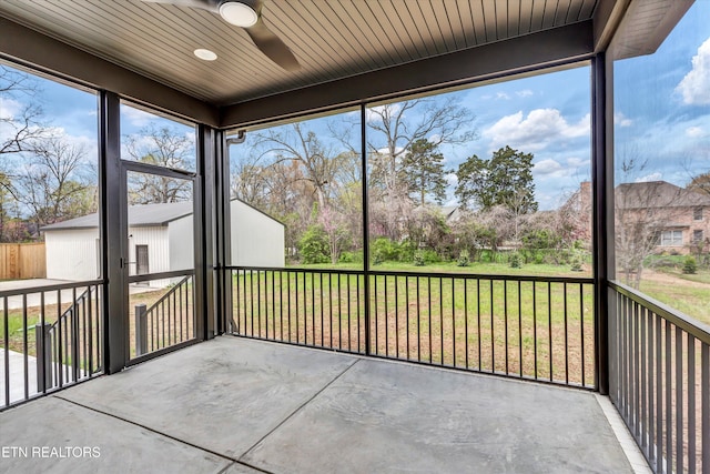 unfurnished sunroom with a healthy amount of sunlight and a ceiling fan