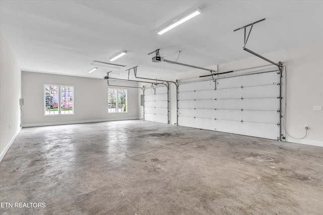 garage with baseboards and a garage door opener