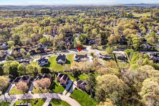 birds eye view of property with a view of trees and a residential view