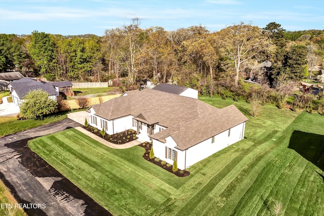 birds eye view of property with a view of trees