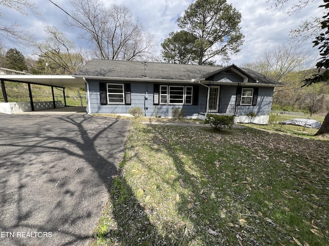 view of front of home featuring an attached carport and driveway