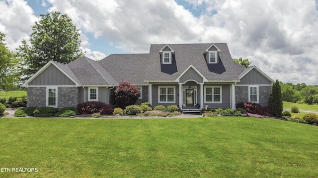 8500 N Ruggles Ferry Pike, Strawberry Plains, TN 37871 - cape cod home with stone siding, board and batten siding, a front yard, and roof with shingles