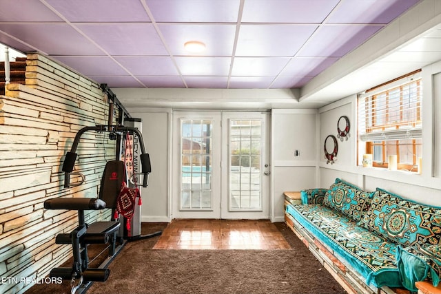 interior space featuring a drop ceiling and carpet flooring