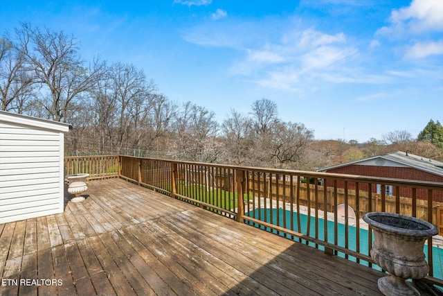 wooden deck with fence and a fenced in pool