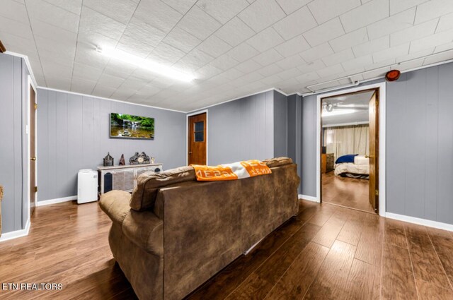 living area featuring baseboards and wood finished floors