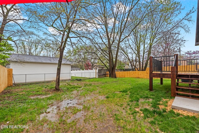 view of yard featuring a fenced backyard, a deck, and stairs