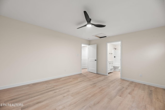 unfurnished bedroom featuring light wood-style flooring, ensuite bathroom, baseboards, and attic access