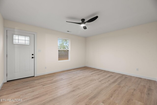 interior space featuring a ceiling fan, a healthy amount of sunlight, light wood finished floors, and visible vents