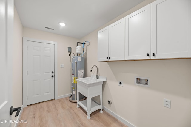 clothes washing area with water heater, electric dryer hookup, visible vents, cabinet space, and hookup for a washing machine