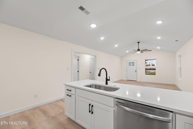kitchen featuring dishwasher, ceiling fan, lofted ceiling, a sink, and light wood-type flooring