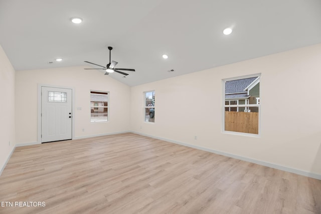 interior space featuring lofted ceiling, baseboards, light wood-style floors, ceiling fan, and recessed lighting