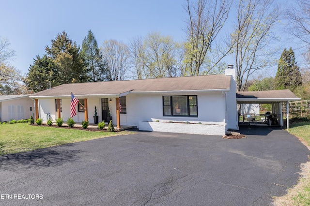 733 Waco Rd, Knoxville, TN 37919 - view of front of property featuring a chimney, a front yard, an attached carport, driveway, and covered porch