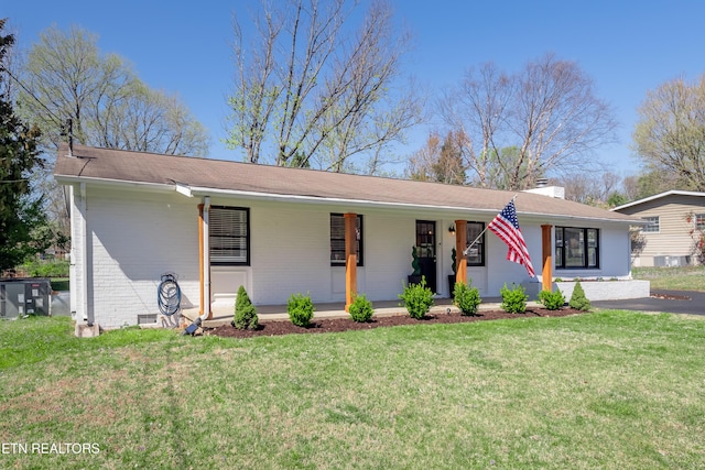 733 Waco Rd, Knoxville, TN 37919 - single story home with a chimney, a front yard, covered porch, and brick siding