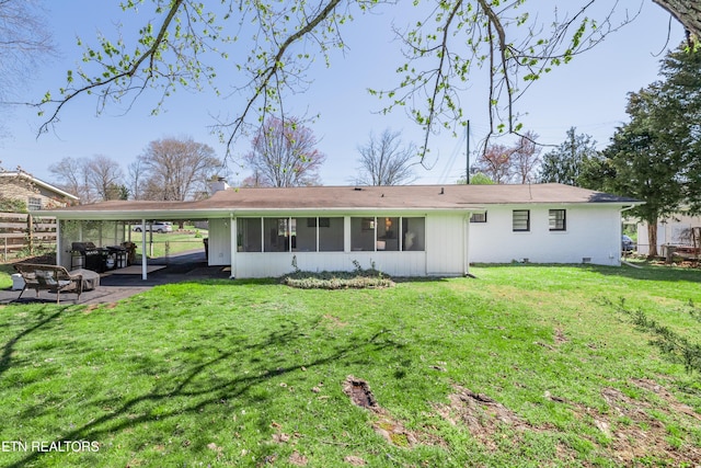 733 Waco Rd, Knoxville, TN 37919 - rear view of house featuring a sunroom, a carport, fence, and a lawn