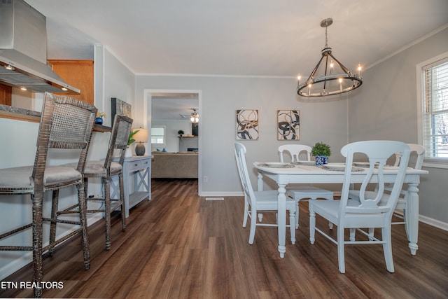 733 Waco Rd, Knoxville, TN 37919 - dining room with a notable chandelier, crown molding, baseboards, and wood finished floors