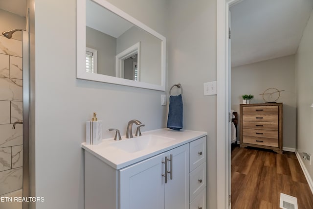 733 Waco Rd, Knoxville, TN 37919 - bathroom featuring wood finished floors, vanity, walk in shower, and visible vents