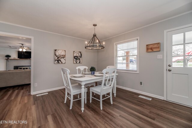 733 Waco Rd, Knoxville, TN 37919 - dining area featuring dark wood-style flooring, crown molding, and an inviting chandelier