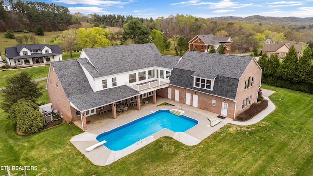 134 At Crumley Rd, Rockford, TN 37853 - back of house with a balcony, a lawn, and brick siding