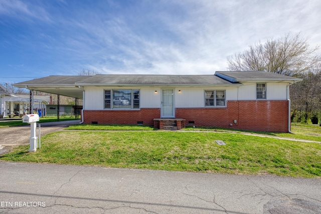view of front of property featuring concrete driveway, crawl space, a front yard, brick siding, and an attached carport