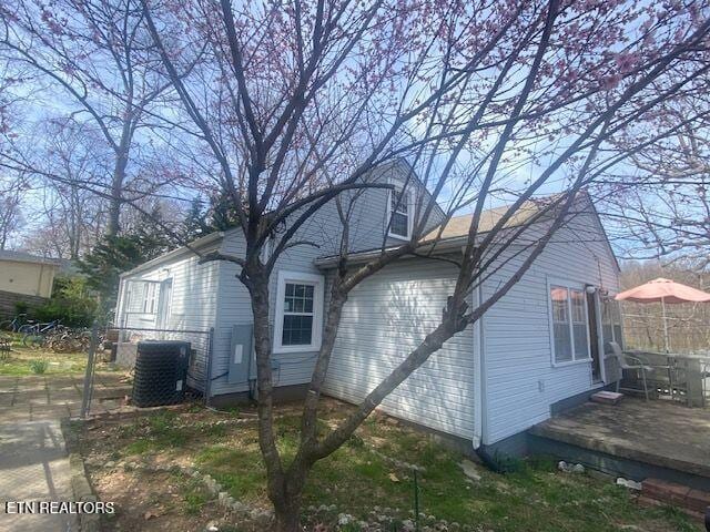 back of house featuring cooling unit