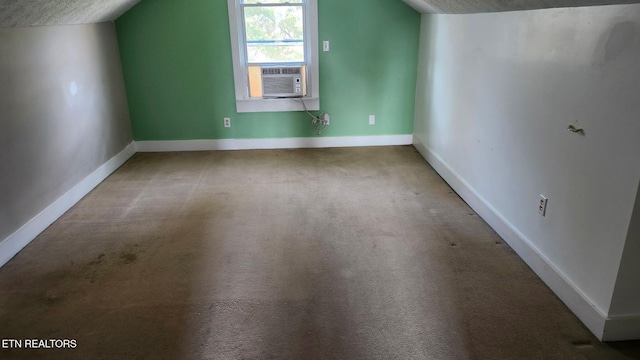 additional living space with baseboards, carpet flooring, cooling unit, and vaulted ceiling