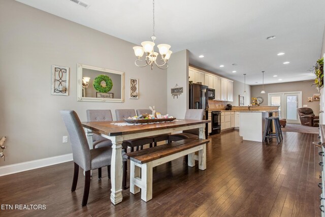 dining room with baseboards, recessed lighting, dark wood-type flooring, and an inviting chandelier