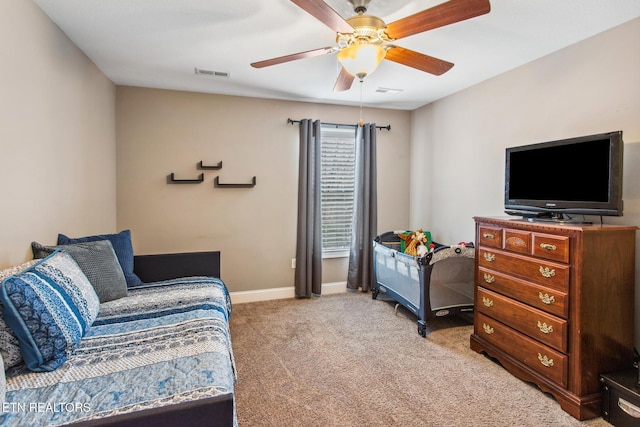 bedroom featuring a ceiling fan, baseboards, light colored carpet, and visible vents