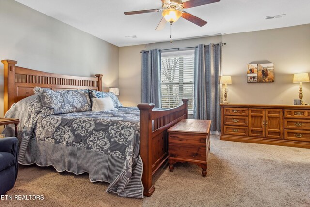 carpeted bedroom with visible vents and ceiling fan