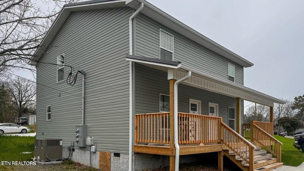 back of property featuring cooling unit, crawl space, and covered porch