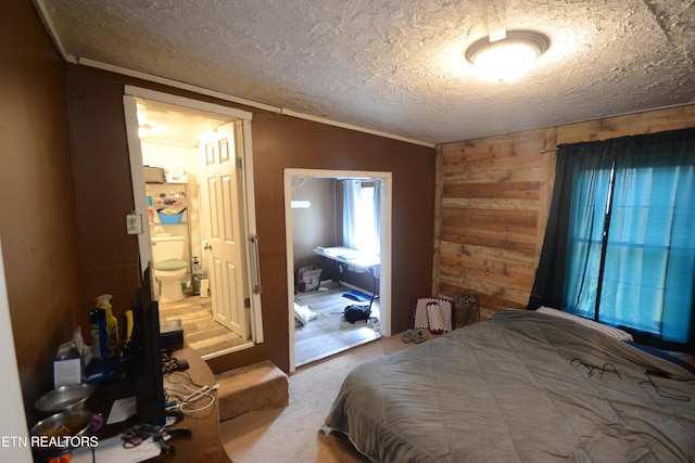 519 Temple Rd, Seymour, TN 37865 - carpeted bedroom featuring ensuite bathroom, a textured ceiling, vaulted ceiling, and wooden walls
