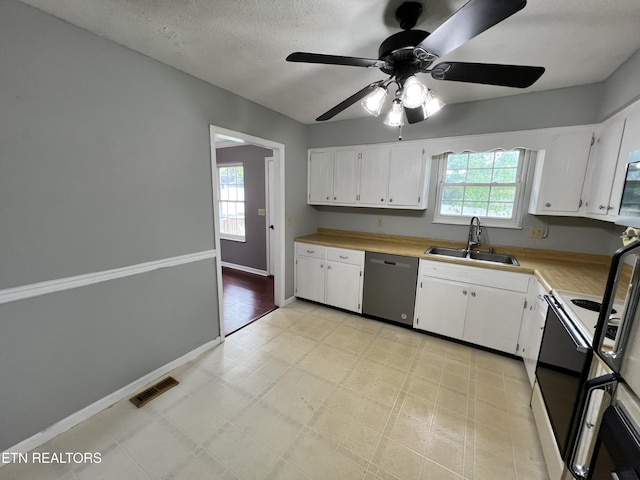 kitchen featuring stainless steel dishwasher, a sink, light floors, electric range, and visible vents