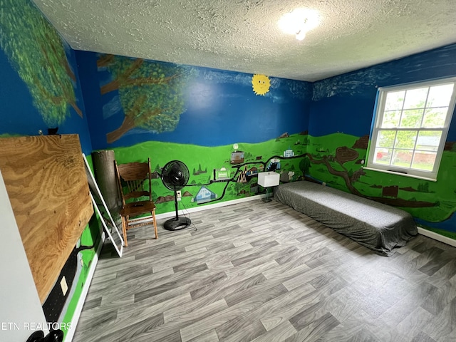 interior space featuring a textured ceiling and baseboards